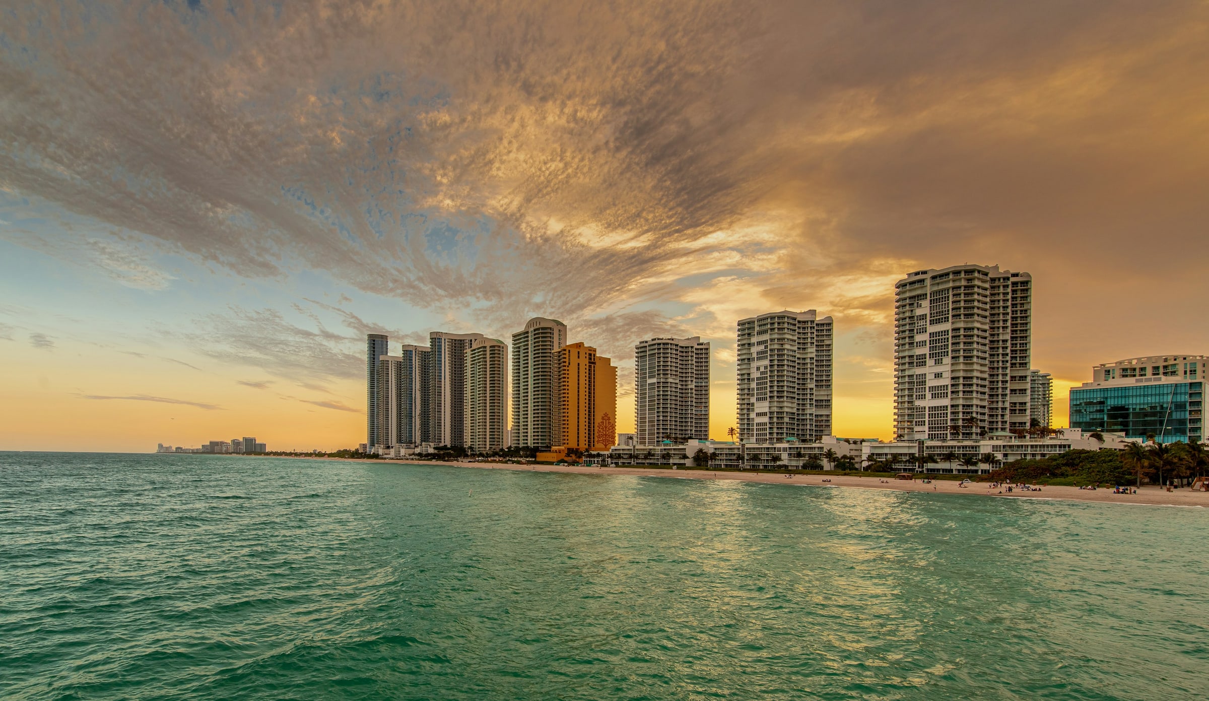 Row of oceanfront condominium towers at Sunny Isles Beach in Miami-Dade County, seen from the water at golden hour